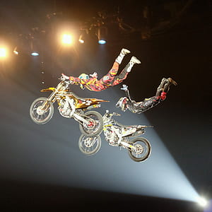 two men performing motorcycle tricks thumbnail