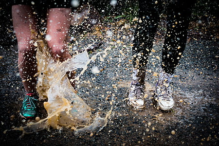 two person stamping on flood water thumbnail