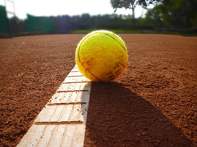 photography of yellow baseball during day time thumbnail