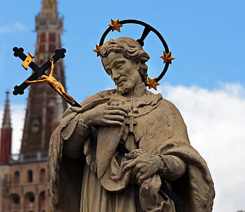 statue of man holding crucifix thumbnail