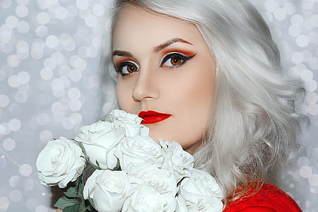 woman holding bunch of white rose flowers thumbnail
