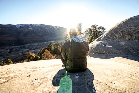 person sitting on canyon near cliff thumbnail