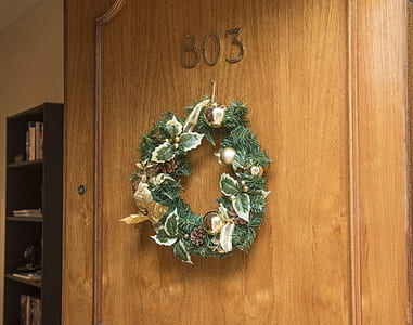 Christmas Wreath Hanging on Brown Wooden Door of Room 803 thumbnail