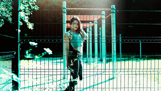 woman in teal crop top and black pants outfit at nighttime thumbnail