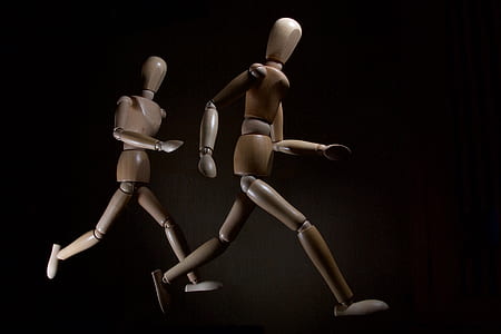 two brown wooden robot toys thumbnail