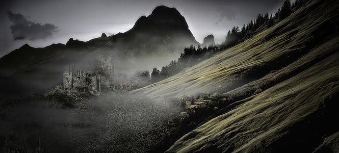 gray castle beside mountain with cloudy sky thumbnail