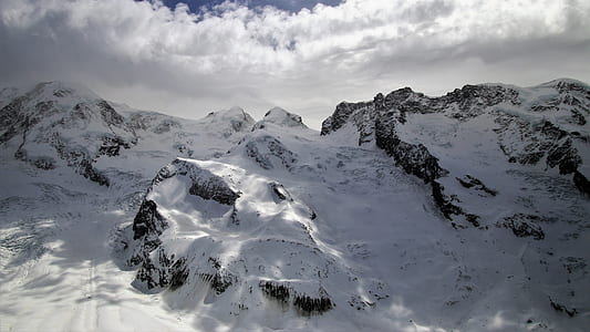 snow covered mountain under cloudy sky thumbnail