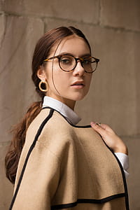woman wearing tortoiseshell framed eyeglasses and brown knit blazer thumbnail