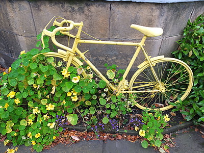 yellow road bicycle leaning on gray wall thumbnail
