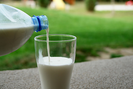 person pouring milk on mug thumbnail