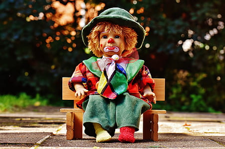 clown doll sitting on bench thumbnail