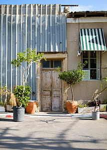 house with brown door near plants thumbnail