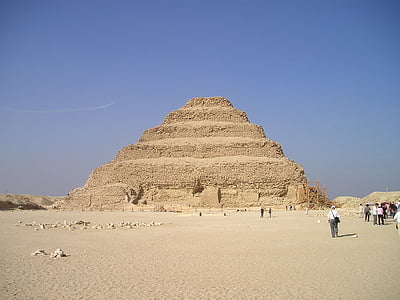 group of people walking beside pyramid during day time thumbnail