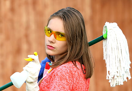 woman holding mop and spray bottle thumbnail