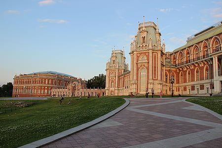 photo of white and red concrete castle under blue sky at daytime thumbnail