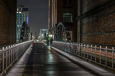 bridge near building during nighttime thumbnail