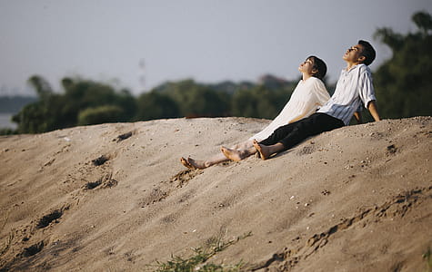Man and Woman Sitting on the Sand thumbnail