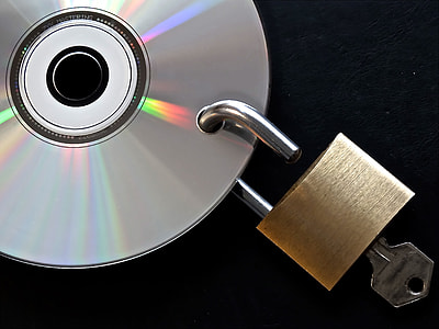 brass padlock with key hanging in gray disc thumbnail