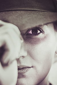 woman holding the tip of her cap thumbnail