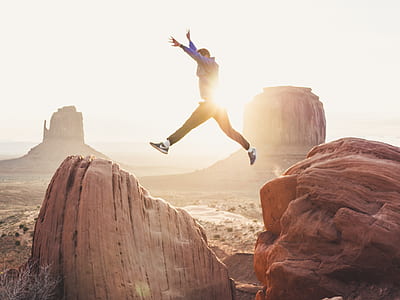 man jumping on mountain cliff thumbnail