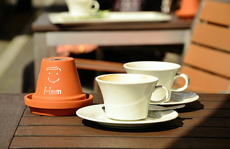 white ceramic teacup on brown wooden table thumbnail