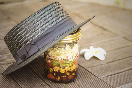 gray wicker fedora on glass jar thumbnail