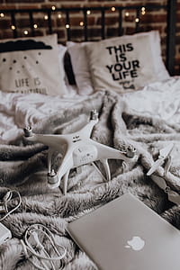 Drone, laptop and accessories lie on the bed ready for travel thumbnail
