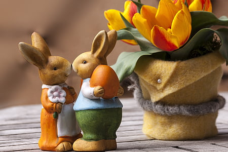 two brown rabbit figurines near yellow tulips flower centerpiece thumbnail