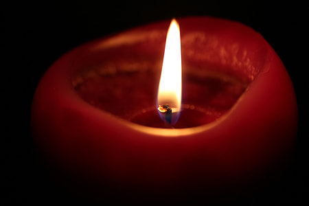lighted red candle selective-focus photography thumbnail
