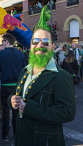 smiling man wearing black suit jacket standing in front of people during daytime thumbnail