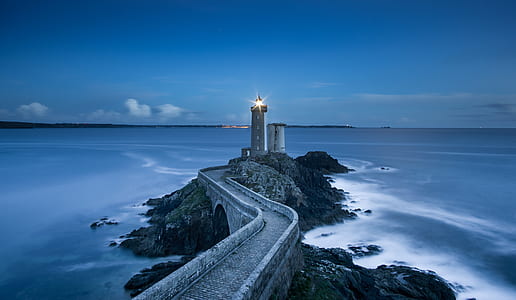 gray concrete lighthouse near body of water thumbnail