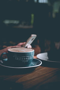 teal cup and saucer on brown surface thumbnail