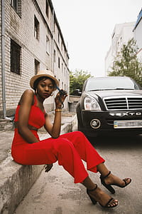 Woman Sitting on Edge Near Car thumbnail