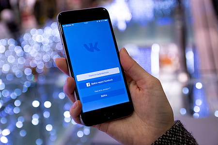 Display with login to the social network Vkontakte on modern smartphone in hands thumbnail