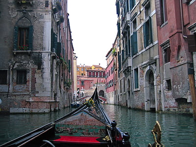 boat on canal between buildings at daytime thumbnail