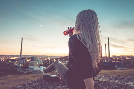 Young Woman Drinking Lemonade and Overlooking the City thumbnail