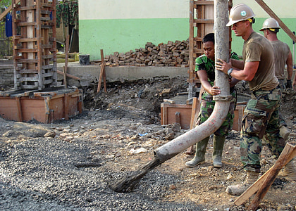 two man holding white tube in front of cement thumbnail