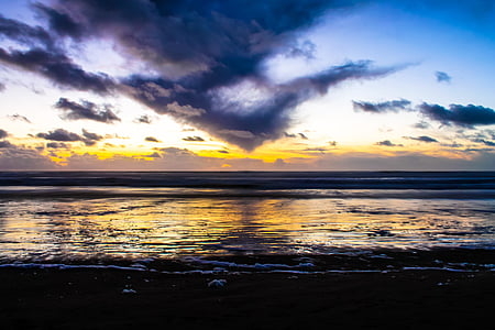 shoreline under white and blue sky at daytime thumbnail