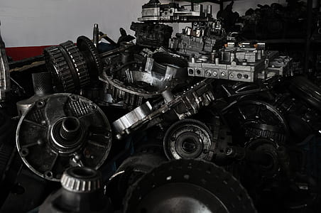 stack of assorted gray vehicle engine parts thumbnail