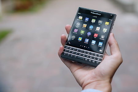 person holding black BlackBerry Passport thumbnail