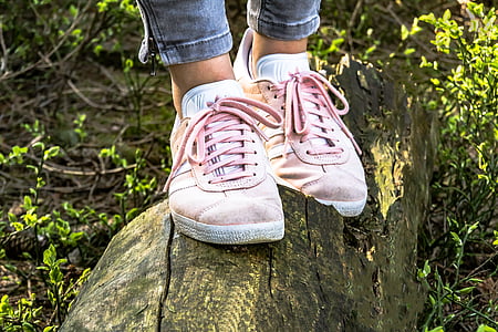 person wearing pair of pink low-top sneakers thumbnail
