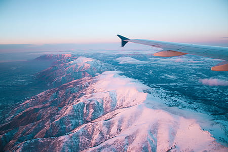 aerial photography of snow-covered mountain and airplane wing thumbnail