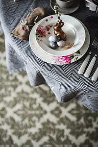 Round dinner table decorated with easter motifs thumbnail