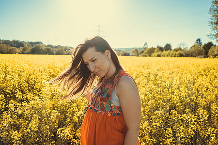 Photo of a Woman Standing by a Flower Field. thumbnail
