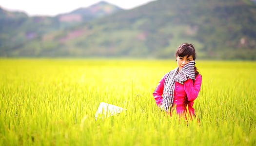 woman in pink coat on grass field thumbnail