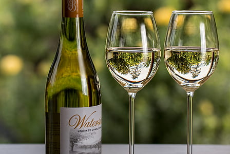 two wine glasses beside wine bottle thumbnail