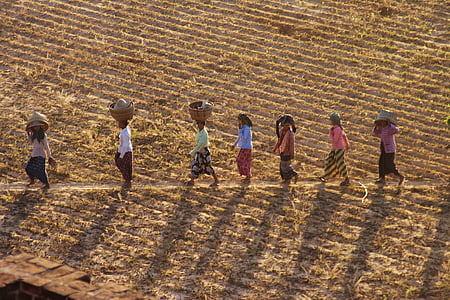 group of people walking aligned carrying basket thumbnail