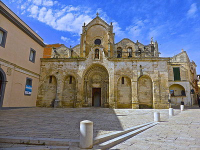 beige concrete church under blue cloudy sky thumbnail