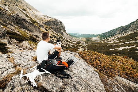 Man Setting Up a Drone for Aerial Photography in Mountains thumbnail