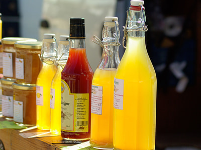 assorted glass bottles on brown wooden surface thumbnail
